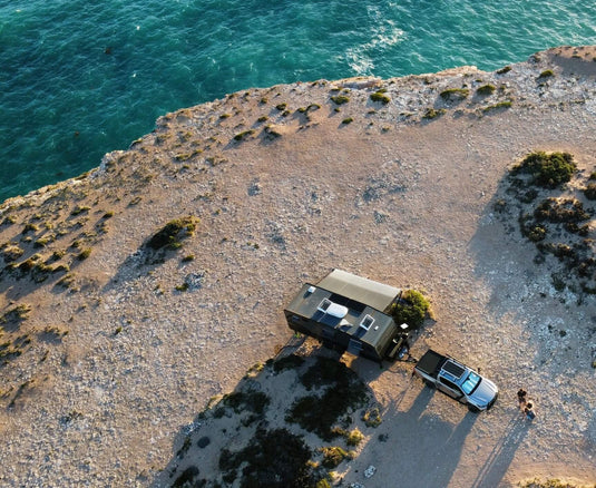 Aerial view of caravan and 4wd at cliff edge