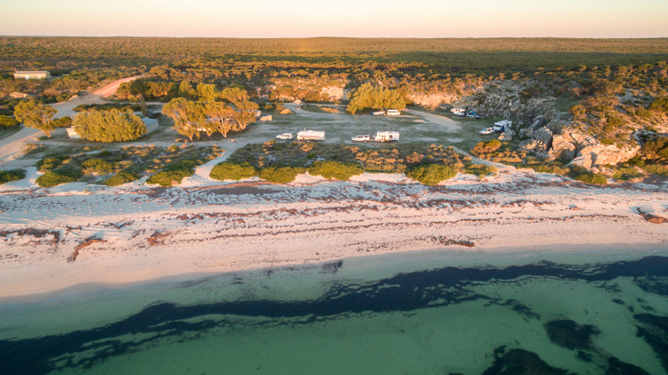 4wd's and caravans at Australian white sand beach